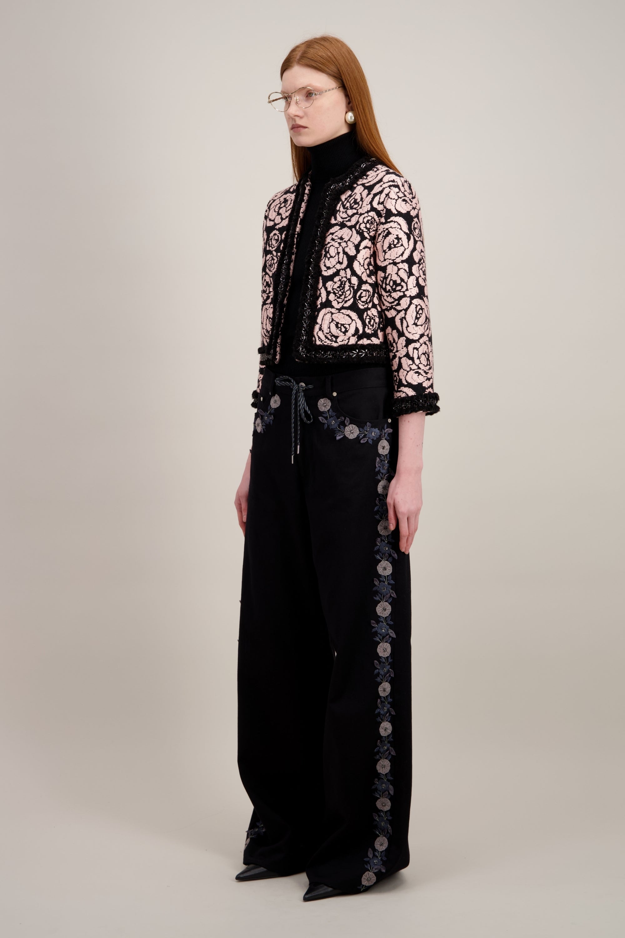 Veste courte en jacquard, noire et sans col. Vu de trois quarts